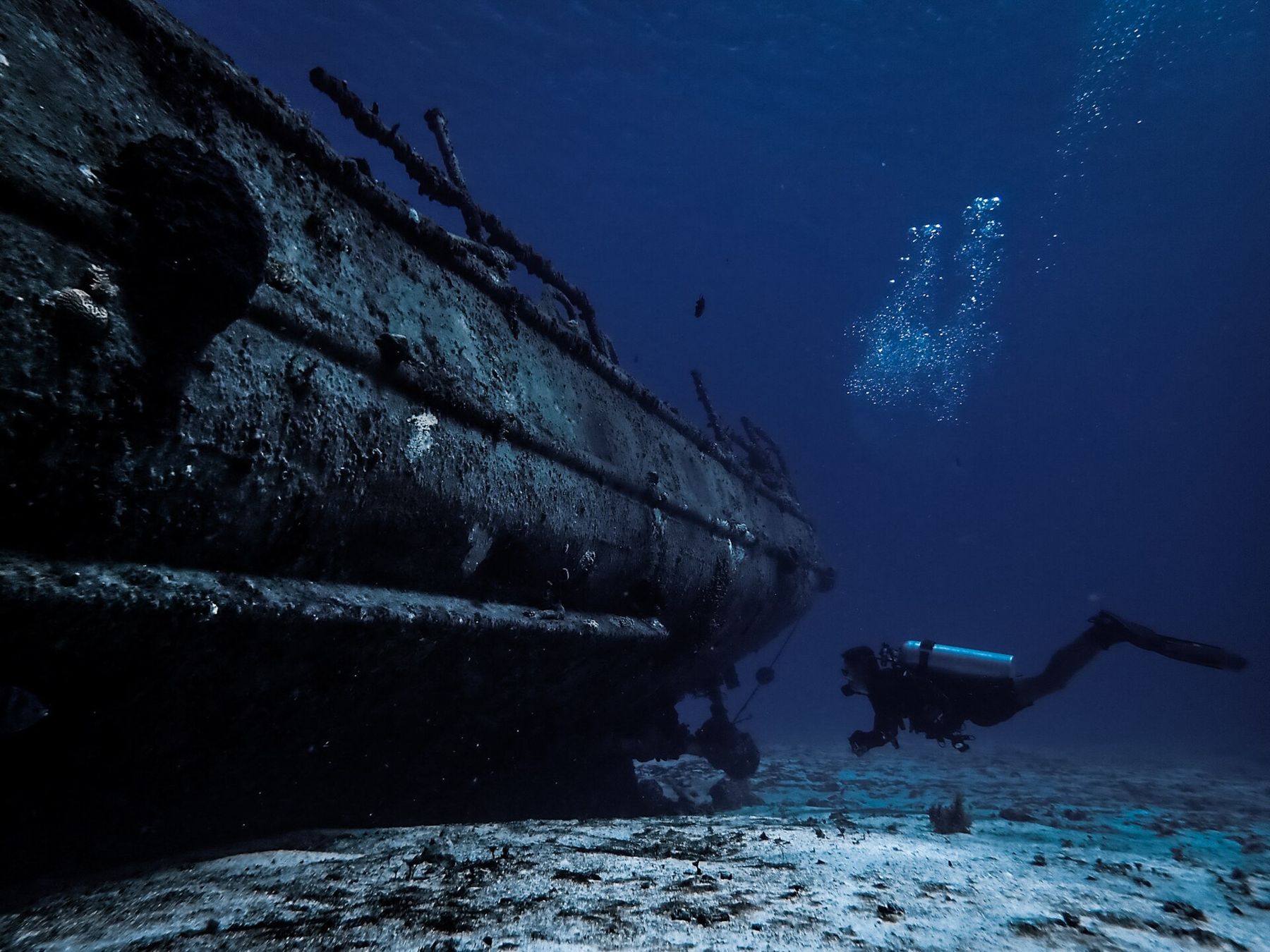 Divers over a sunken ship in Cozumel